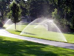 Lawn being watered by sprinkler system
